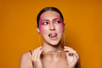 Young beautiful woman fashion glasses pink face makeup posing attractive look isolated background unaltered