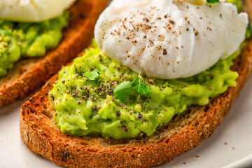 Avocado toast with poached egg close up