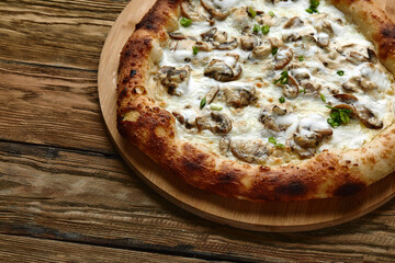Delicious homemade pizza with mozzarella, mushrooms, beef and chicken. Wooden background, selective focus.