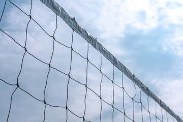 Sport white volleyball nets or mesh stretched under the clear and bright blue summer sky