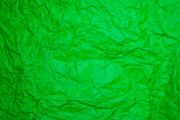 Textured green paper background.