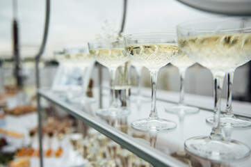 Glasses of champagne at the Banquet, white sparkling wine in wine glasses, festive mood
