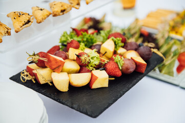 Sandwiches, canapes and cakes on the festive table. A wide variety of snacks