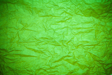 Green paper crumpled background.