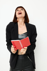Fototapeta premium attractive woman in a black jacket notepad writing ideas light background