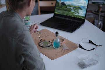 woman fixes glass plates. A picture of dried flowers. Master class on creating frame. be more...