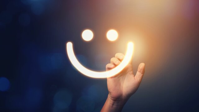 Hand of client show a feedback with smiley face. Customer service and Satisfaction concept Rating very impressed.