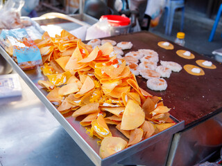 Khanom Buang Thai or a kind of filled pancake Thai food or Thai Style small Crispy Tart on local market tray, Thailand.