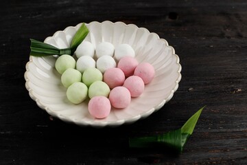Raw Red, Green, and White Tangyuan Glutinous Rice Dumpling Balls on Wooden Table