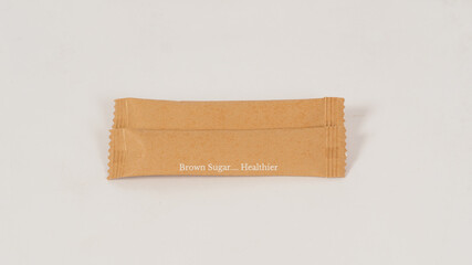 Two Brown sugar sachets on white blackground.