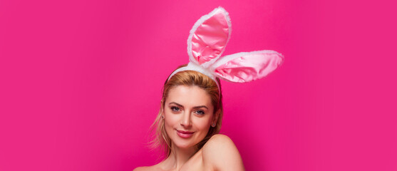 Easter banner with bunny woman. Easter bunny woman. Studio shot of a young woman wearing bunny ears.