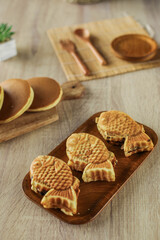 Japanese popular dessert, Taiyaki and dorayaki served on a wooden plate