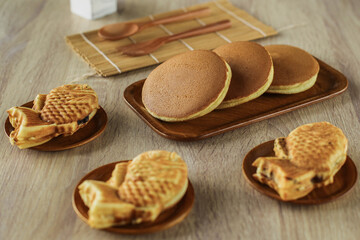 Japanese popular dessert, Taiyaki and dorayaki served on a wooden plate