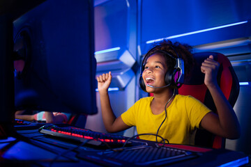 Cute young girl feeling happy and excited for winning computer video game.