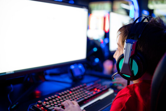 Children addicted to entertaining industry playing video games on computer in free time.
