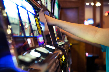 Fototapeta na wymiar People Playing Casino Slot Machines Close Up