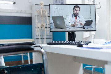 Compute screen with remote therapist doctor explaining during online videocall meeting conference...