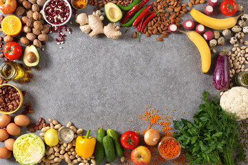 A frame of organic products on gray concrete , vegetarian assortment