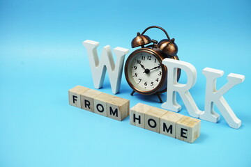 Work from Home alphabet letters with alarm clock on blue background