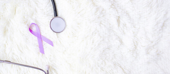 World cancer day (February 4). Lavender purple ribbon with stethoscope for supporting people living...