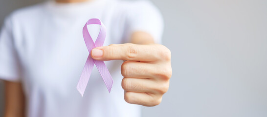 World cancer day (February 4). Woman hand holding Lavender purple ribbon for supporting people...