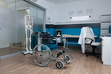 Medical wheelchair for invalid patient standing in empty doctor office with nobody in it ready for...