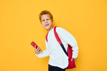 teenager boy use the phone education kids lifestyle yellow background