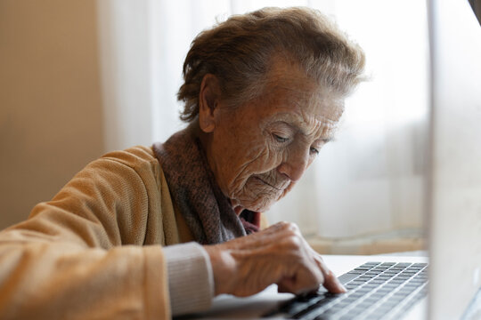 Elderly Woman Using Laptop At Home