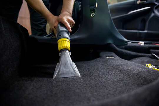 Dry cleaning of car interior with vacuum cleaner. car dry cleaning