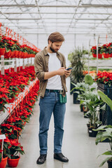 Fototapeta na wymiar Man florist working in green house