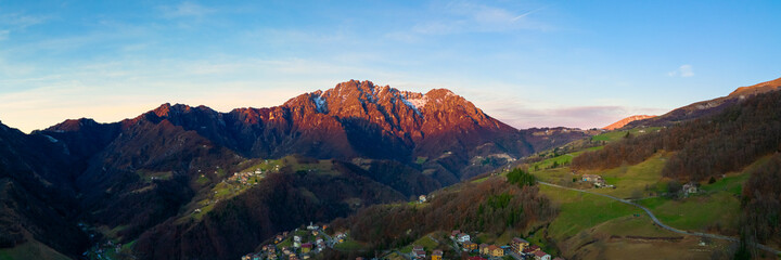 Obraz premium Beautiful panorama of the Seriana valley and its mountains at sunrise, Orobie Alps, Bergamo, Italy