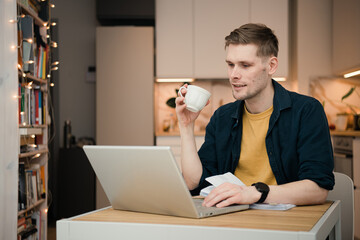 Man in home office. Coffee morning in video call screen. Morning coffee break during work. Man...