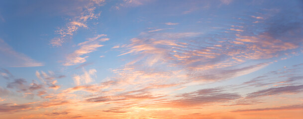 romantic colorful sunset panorama sky with rippled clouds