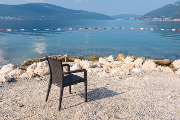 Fototapeta na wymiar An empty beach chair by the Adriatic seaside in Montenegro. 