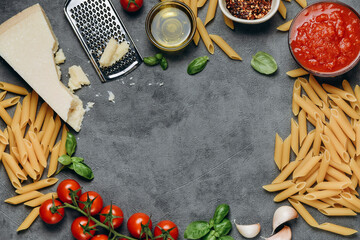 food background Pasta spaghetti,  parmesan cheese, olive oil, spices, basil, tomato sauce and fresh...