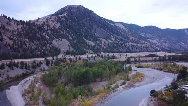 Aerial views and a pan right, over the Similkameen River in Keremeos, British Columbia.