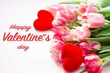 Valentine's Day card  . Tulip flowers, and two red hearts on a pastel pink background with  text  Happy Valentines day . copy space for text . Valentine's day  concept.