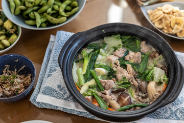 Bowl with chicken with vegetables over the table