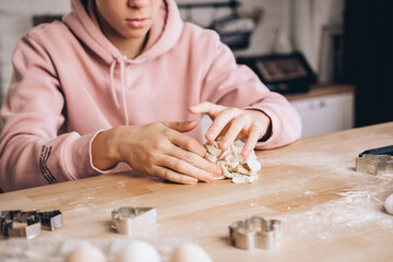 Homemade cooking teenage boy makes dough for pizza