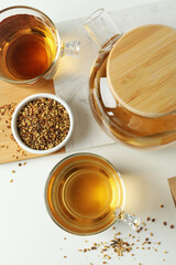 Concept of hot drink with buckwheat tea on white background