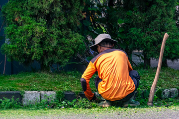Man public worker tidy up the city street yard with on the street
