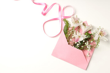 Envelope with flowers and 8 made of ribbon on white background