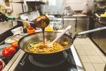 street food. fried noodles in a wok with chicken and shrimp on the wok.