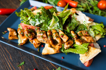 Health food for fitness with chicken, vegetables, herbs, spices and olive oil. High in antioxidants, minerals and vitamins. Healthy homemade chicken salad, diet food, vitamin snack.