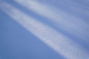 Fototapeta na wymiar smooth snow surface and diagonal shadows