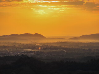 Amazing Sunrise Over Misty Landscape. Scenic View Of Foggy Morning Sky With Rising Sun Above Misty Forest