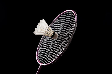 Badminton shuttlecock and badminton racket on black background