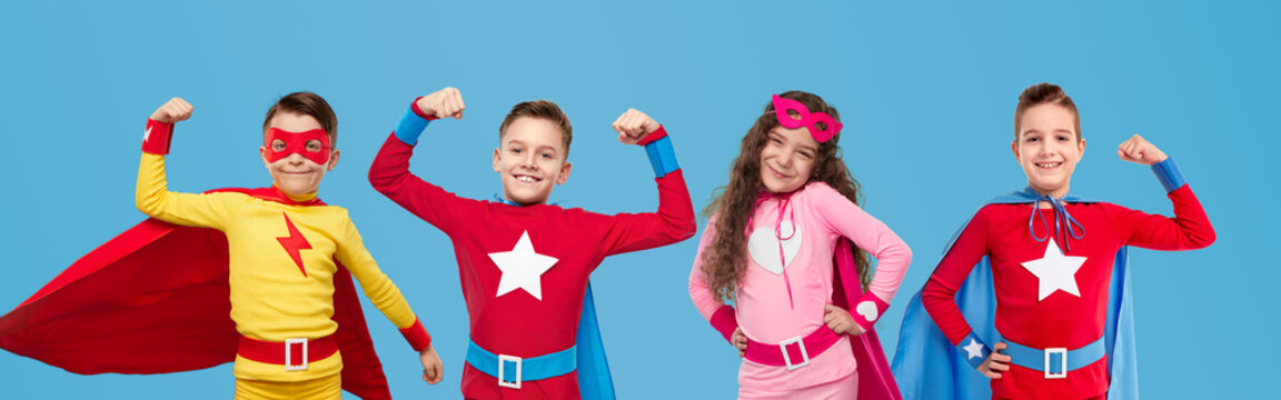 Cheerful kids in hero costumes showing superpowers