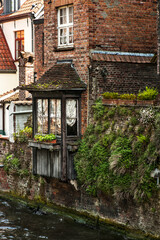 Old brick houses in Bruges. Medieval ancient houses made of old bricks at water channel in Bruges.