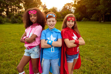 Company of diverse kids in superhero costumes